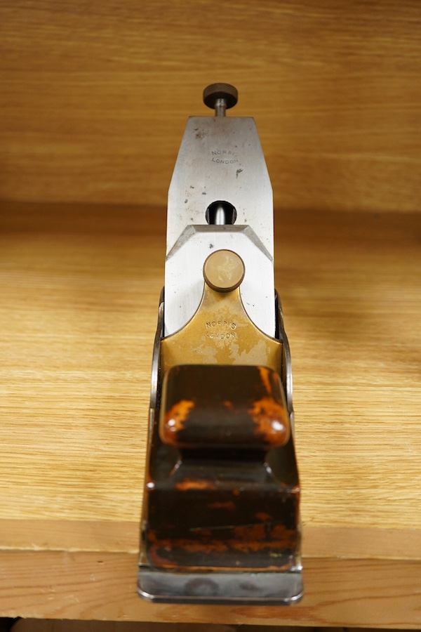 A Norris A1 adjustable steel 14 1/2” panel plane, stamped with Norris, London to both the brass lever cap and the iron, with rosewood infill